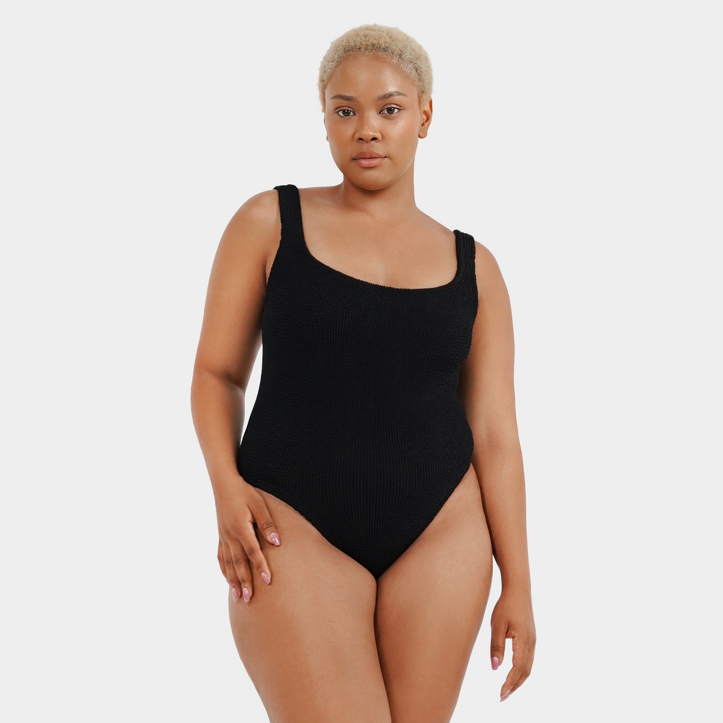 Curvy model wearing the one size crinkle swimsuit in midnight black