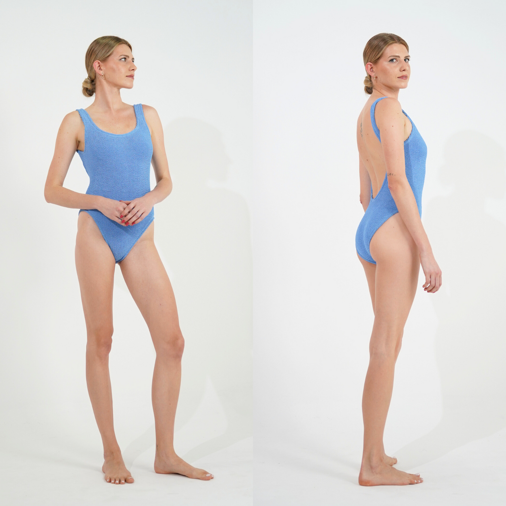 Tall model wearing the one size crinkle swimsuit in cornflower blue