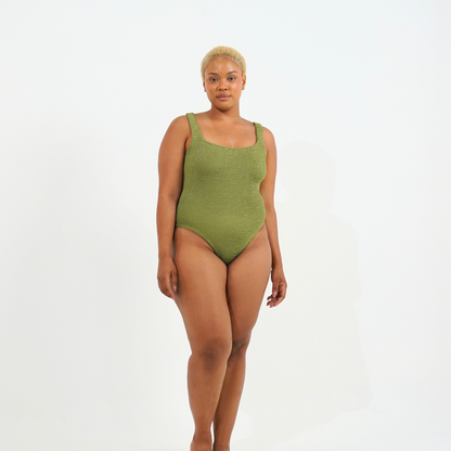 Curvy model wearing the crinkle swimsuit in golden sage, front view