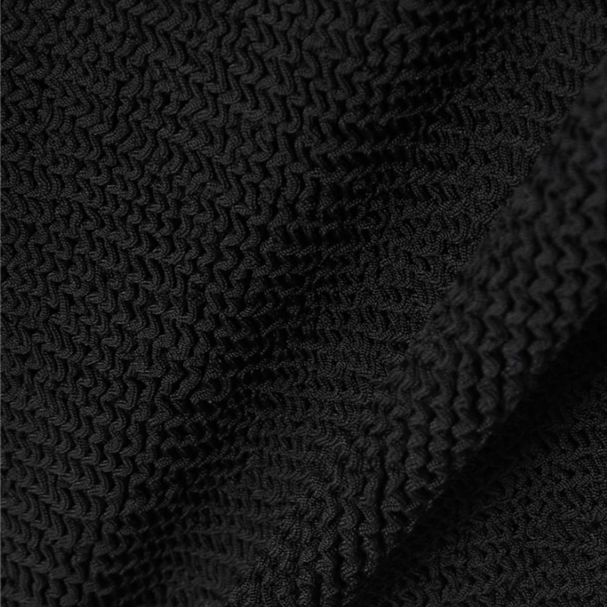 Close-up of the crinkle fabric texture in midnight black